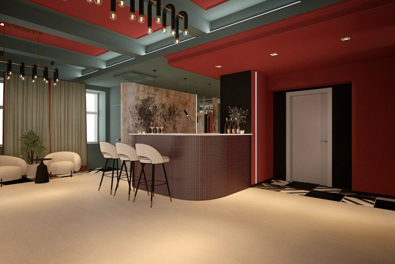 Арендовать Стильное пространство Астрид. Многофункциональное помещение с барной стойкой в центре, за которой размещены три стула. Слева зона отдыха с двумя креслами и растением. Потолок темный с подвесными светильниками. Стены окрашены в красный цвет, пол светлый, на стене крупная картина.