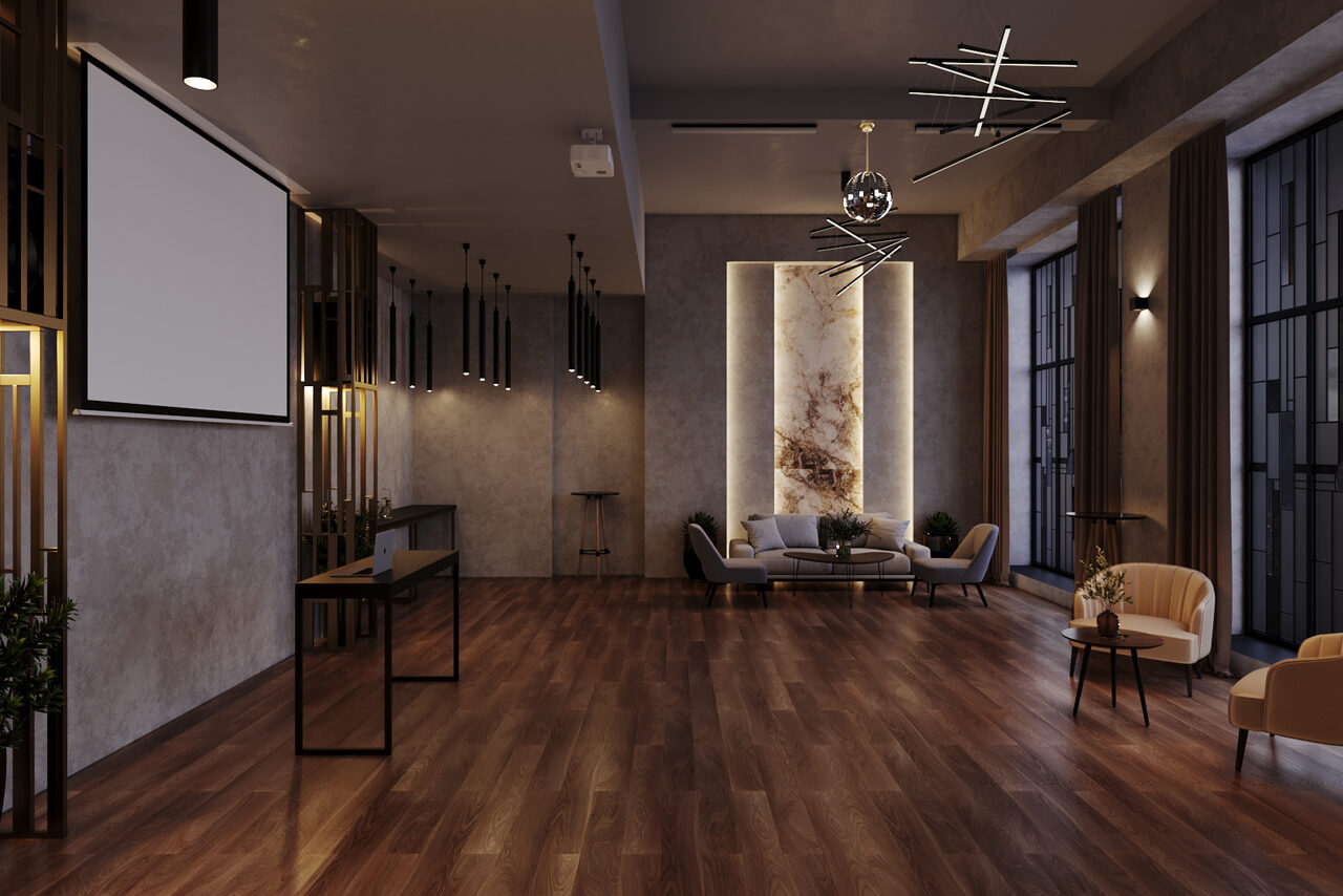 Арендовать Лофт Мираж. Просторное помещение с деревянным полом, серыми стенами и современной мебелью: диваны, кресла и столы. Большие окна, проектор и экран, стильные светильники на потолке, декоративная подсветка на стене.