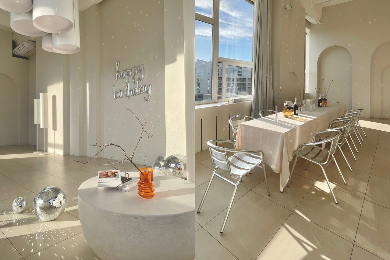 Арендовать Роскошный панорамный лофт . Вид сверху. Стол с накрытой посудой. Декоративная подставка с книгами. Диско-шары на полу