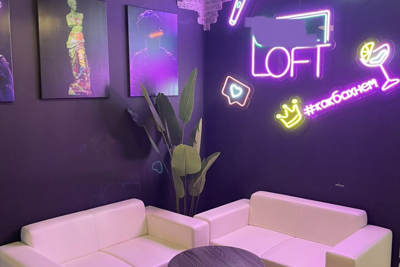 Арендовать Loft with stage near the metro . Неоновая подсветка, картины на стенах. Диваны с журнальным столиком